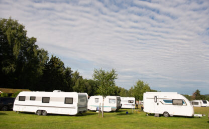 Husvagnar på Flottsbro camping, i bakgrunden syns en skog.